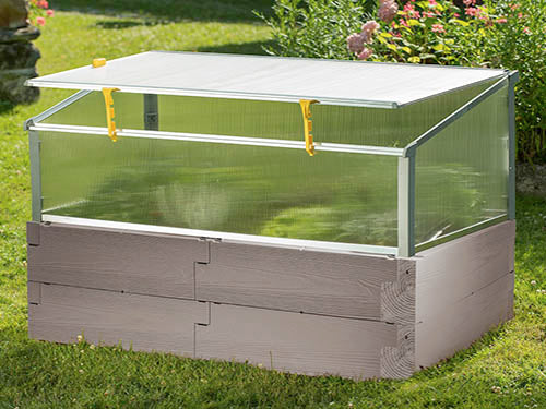 Raised garden bed with weather-resistant poly timber texture and clear polycarbonate cold frame cover on grass
