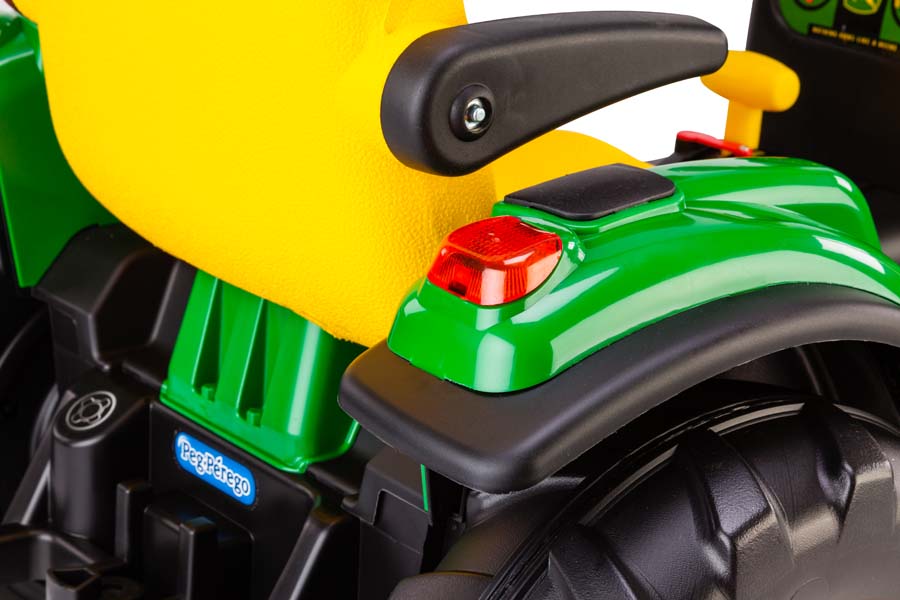 Green and yellow children's ride-on tractor seat with black armrest and rear light detail