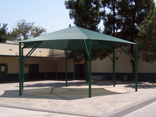 Green hexagonal shade canopy with six metal posts over paved outdoor area providing sun protection