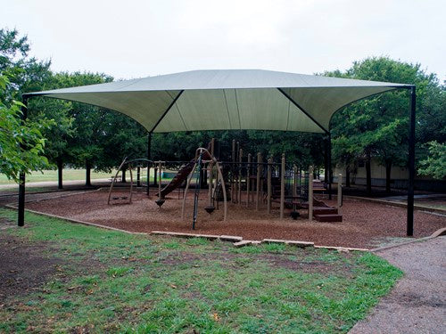 Hip Roof Shade Structure with 4 Posts and 14 Foot Entry, rectangular fabric canopy blocking UV rays over playground equipment