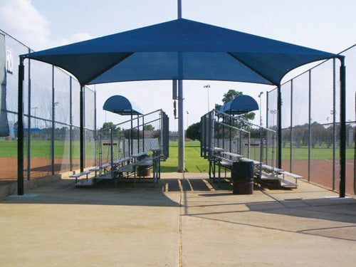 Rectangular hip roof shade structure with four posts covering outdoor bleachers and basketball hoops at sports field