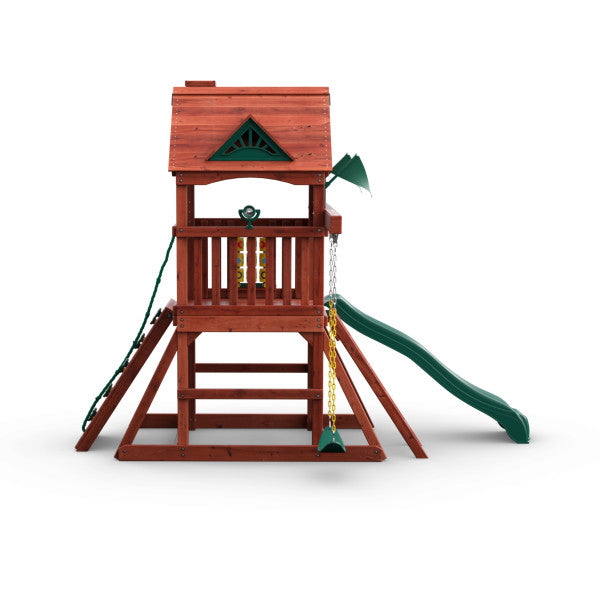 Compact wooden playset with green wave slide, two belt swings, climbing wall with rope, tic-tac-toe panel, and sandbox area
