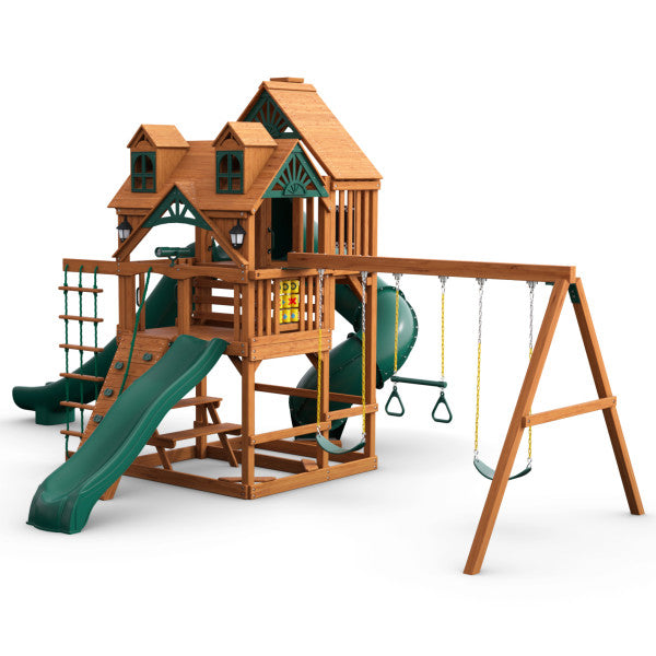 Cedar wooden playset with green slides, climbing wall, rope ladder, swings, tic-tac-toe panel, and wood roof