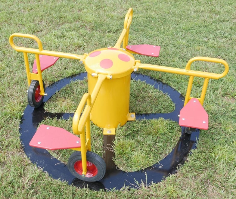 Four-seat inground playground rider with yellow frame, red seats, and wheels on grass surface