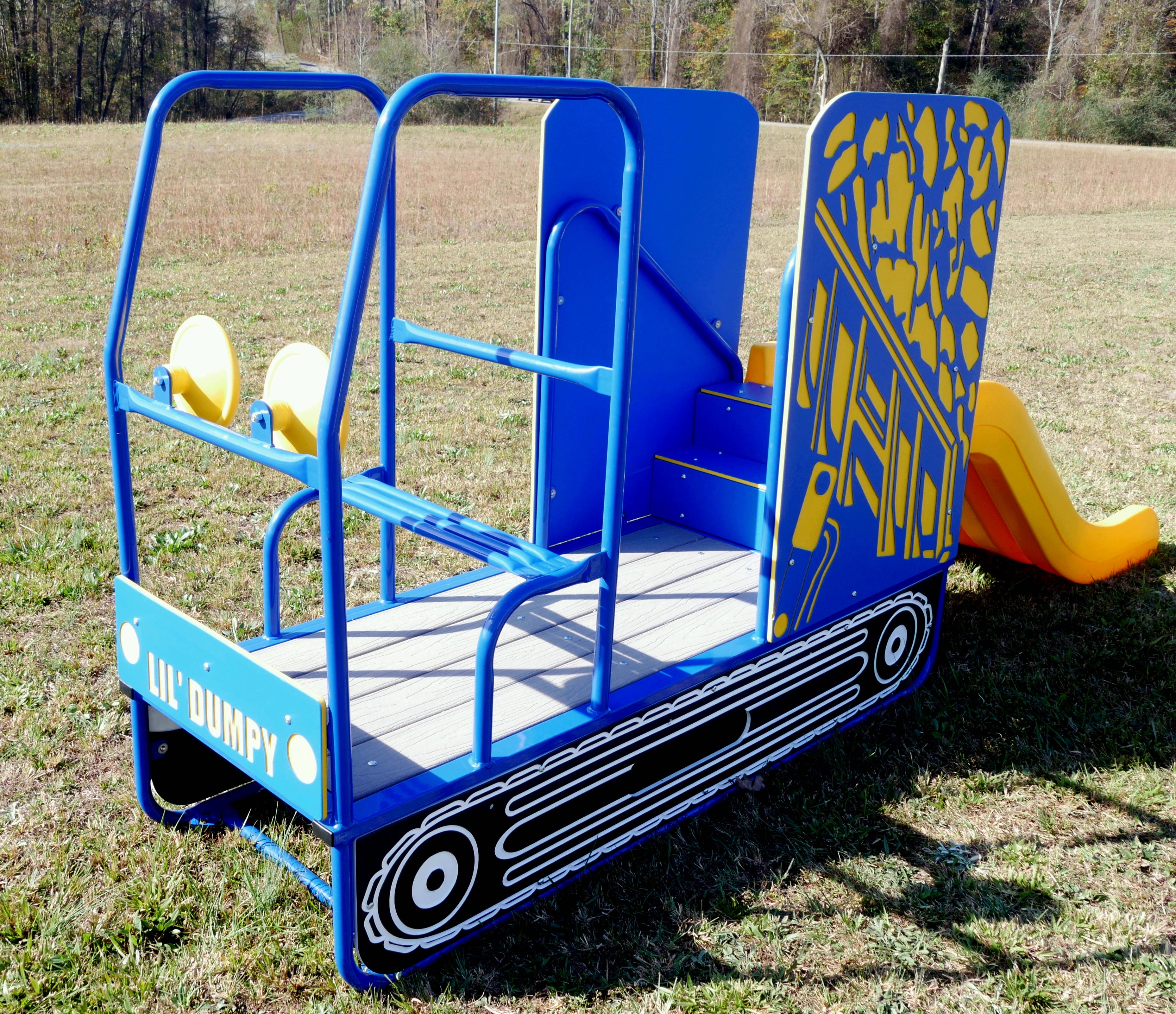 Blue and yellow dump truck-themed playground slide with twin steering wheels, entry steps, and smooth yellow slide