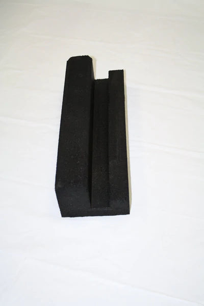 Black molded recycled rubber curb section with key-way groove for securing loose fill and turf containment
