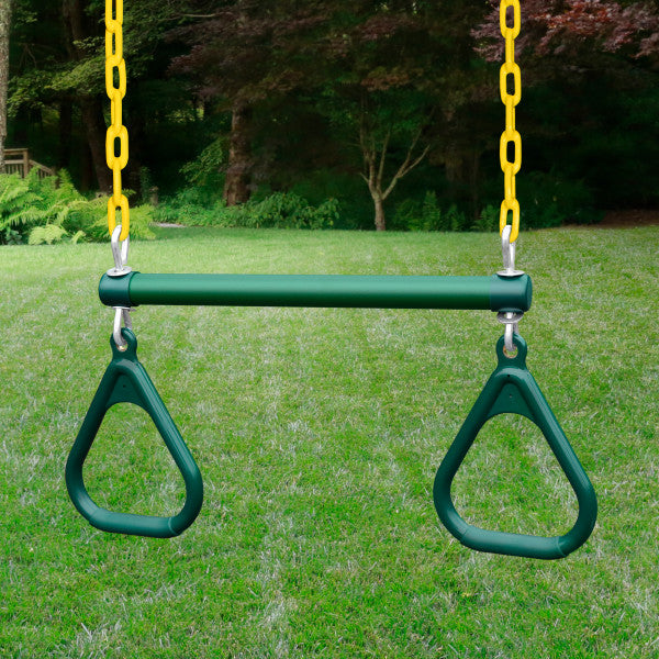 Green trapeze swing with yellow chains attached to wooden playset on grassy lawn