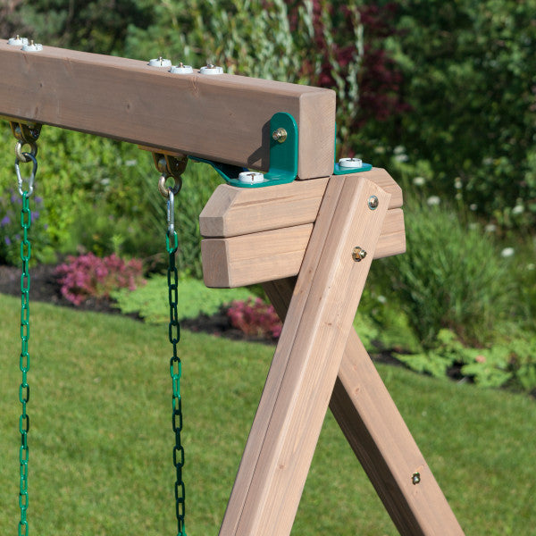 Close-up of cedar wood swing set frame with green metal brackets and hanging swing chains in garden setting