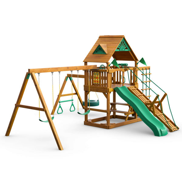 Wooden playset with green slide, climbing ramp, tire swing, trapeze rings, and tic-tac-toe panel