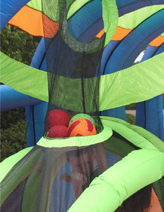 Inflatable sports bouncer with colorful soft balls caught in black mesh net above green and blue structure
