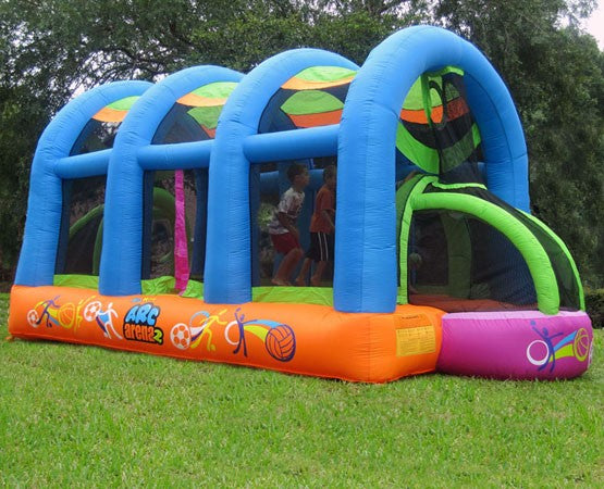 Inflatable sports bounce house with blue arches, orange base, colorful soccer and basketball graphics, children playing inside.
