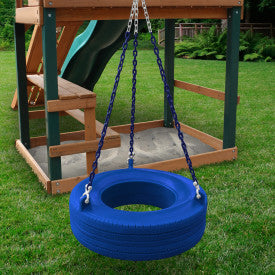 Blue enclosed plastic tire swing with coated chains hanging from wooden playset in grassy backyard