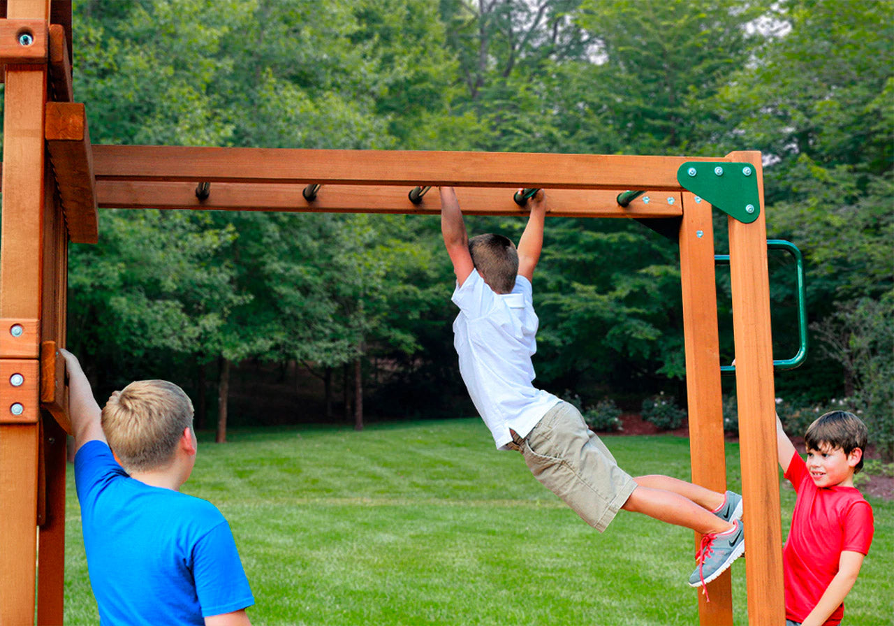 Wooden swing set with heavy-duty metal monkey bars, three children playing on green grass outdoors
