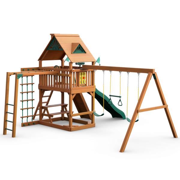Cedar wooden swing set with green slide, trapeze bar, rope ladder, tic-tac-toe panel, and picnic table under wood roof