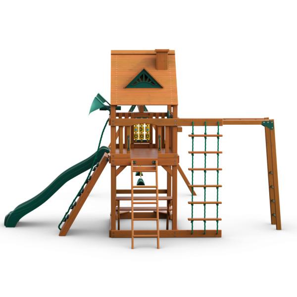 Cedar wooden swing set with green vinyl canopy, green slide, climbing wall, rope ladder, tic-tac-toe panel, and trapeze swing