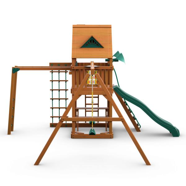 Cedar wooden swing set with green slide, rope ladder, trapeze swing, tic-tac-toe panel, and amber finish canopy