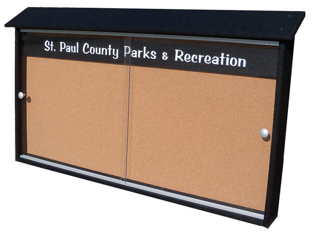 Outdoor black-framed community bulletin board with sliding clear acrylic doors and cork backing, labeled for parks and recreation use