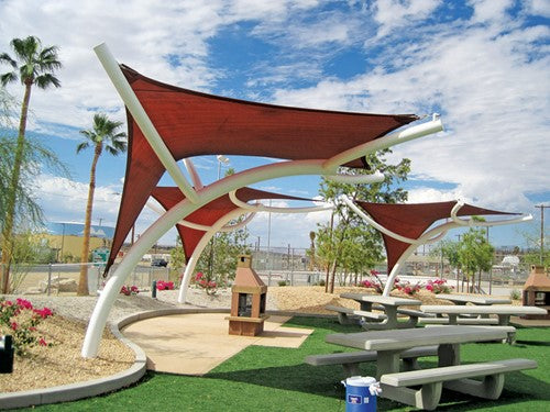 Pegasus Shade Structure with modern red fabric canopies over picnic tables in a sunny urban park setting