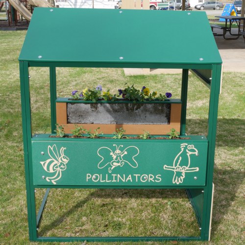 Green playhouse planter with clear root view, live plants, and cartoon pollinator figures for educational gardening play