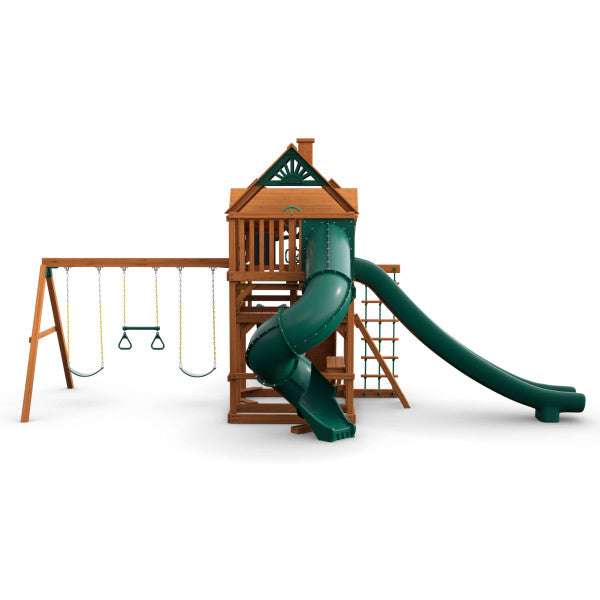 Wooden playset with green turbo tube slide, alpine wave slide, three swings, climbing ladder, and wood roof with sunburst detail