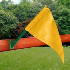 Yellow canvas flag attached to green pole mounted on wooden swing set beam outdoors