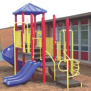 Colorful modular playground with red posts, yellow railings, blue slides, and climbing features on wood chip surface