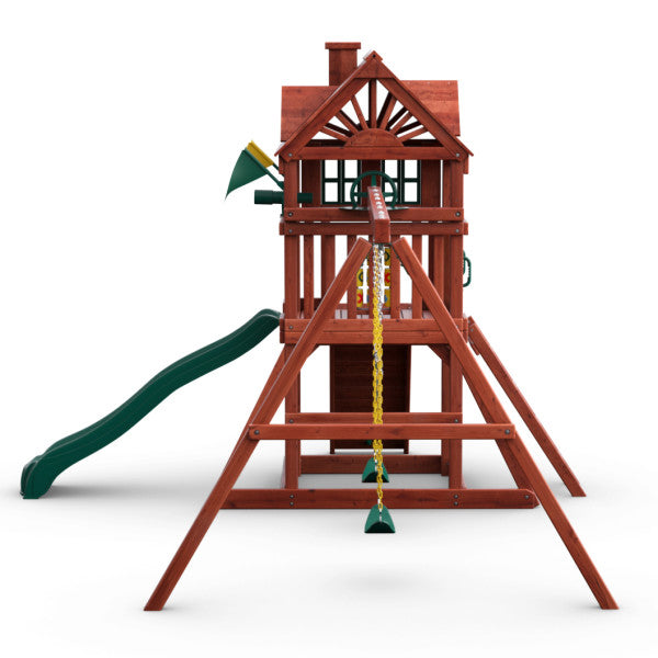Redwood-finished wooden playset with clubhouse, green wave slide, swings, climbing wall, and tic-tac-toe panel
