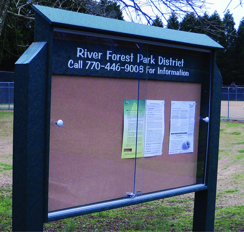 Outdoor park bulletin board with glass sliding doors, cork surface, and black weather-resistant frame for community event displays
