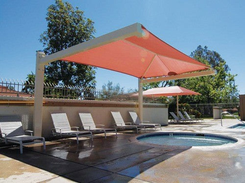 Full Cantilever Hip Roof Shade Structure with rectangular cantilever posts providing poolside shade over lounge chairs and hot tub area