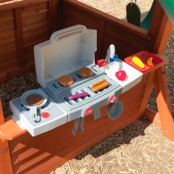 Children’s wooden playset platform with built-in BBQ kitchen, grill, sink, and colorful plastic food toys