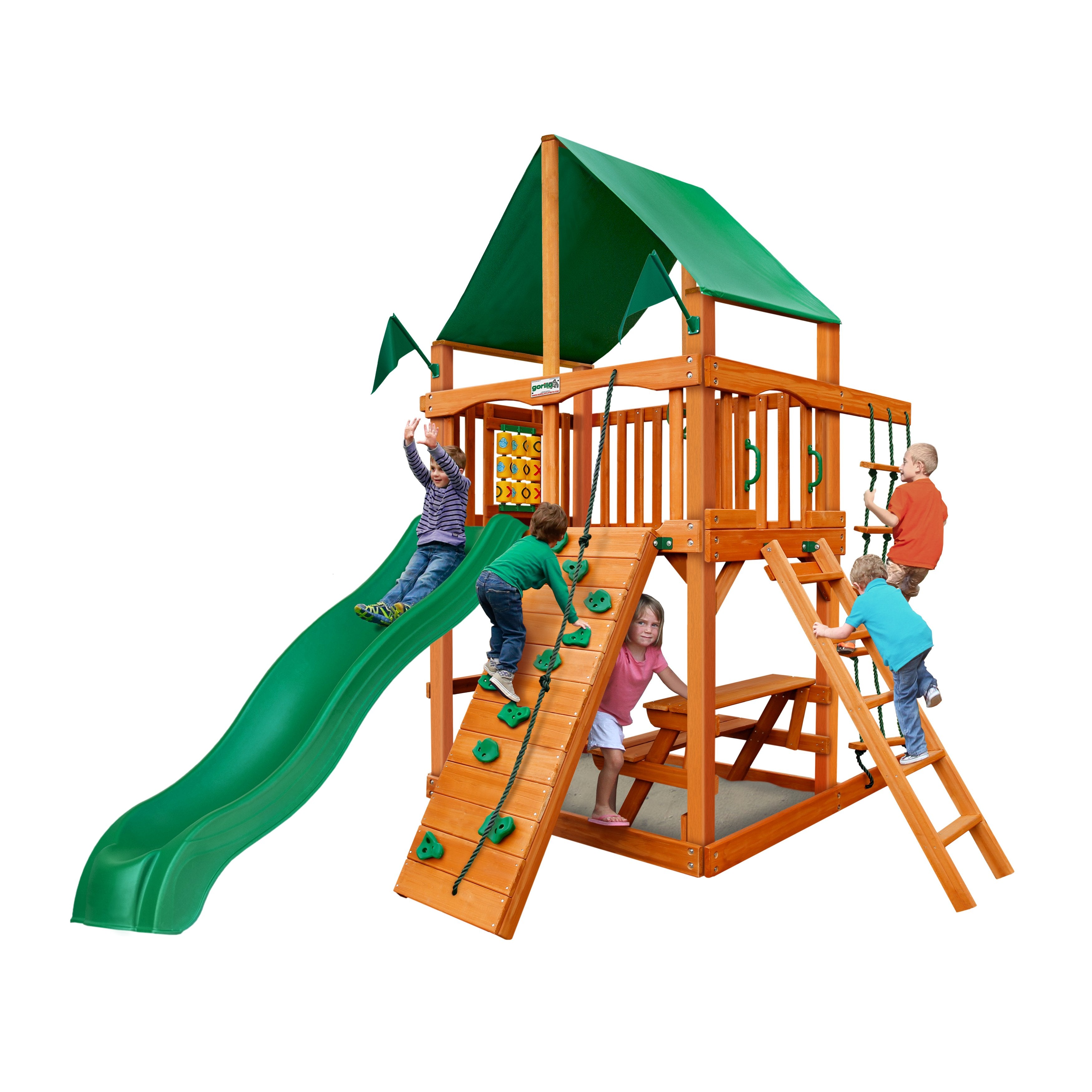 Wooden playset with green vinyl canopy, green wave slide, rock climbing wall, rope ladder, and children playing