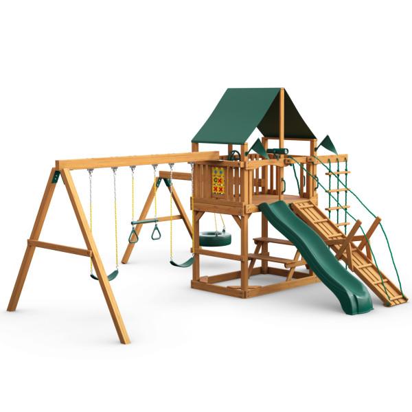 Wooden playset with green vinyl canopy, slide, climbing ramp, tire swing, trapeze, and two belt swings