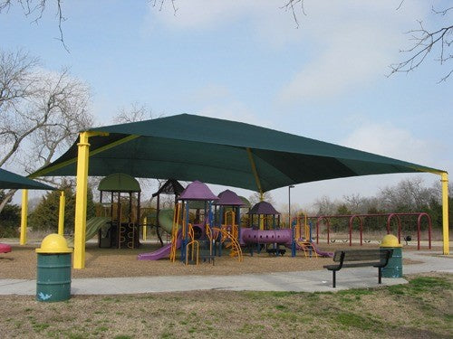 Rectangle hip roof shade structure with green fabric and yellow posts covering colorful playground equipment and swings