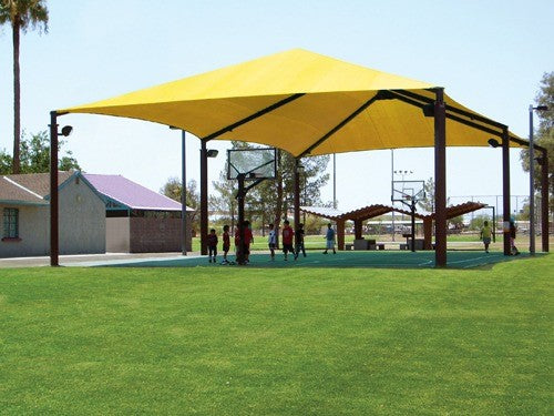 Extended Superspan Hip Roof Shade Structure with 6 posts, yellow fabric canopy over outdoor basketball court and grassy park area
