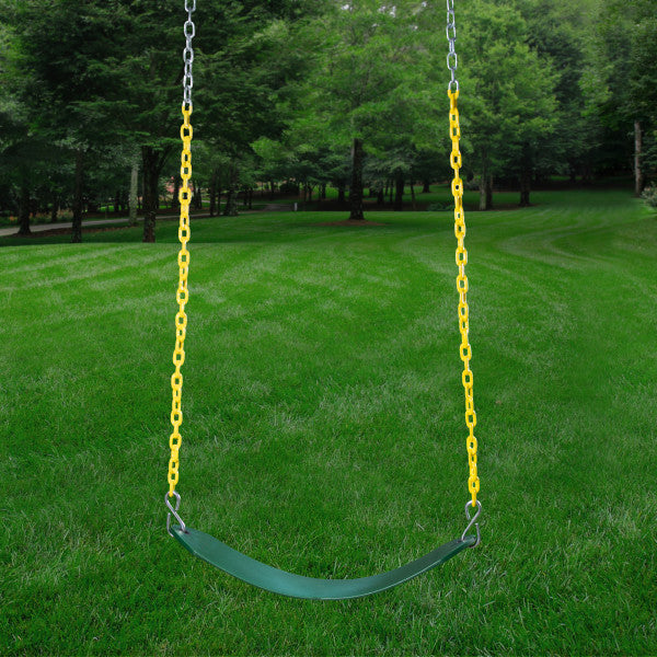 Green flexible swing seat suspended by yellow and silver chains over grass with trees in the background