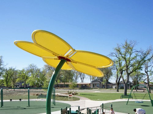 Flower Shade Structure with bright yellow petal canopy providing shade in a sunny playground setting