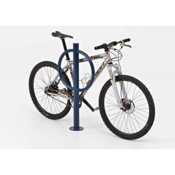 Blue steel bollard-style bike rack with circular locking ring securing a mountain bike, angled side view