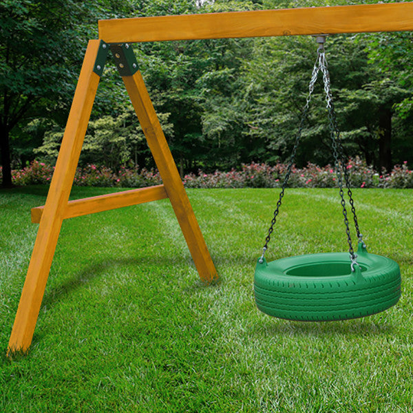 Amber-finished wooden swing set frame with green 360° turbo tire swing hanging by metal chains over grass