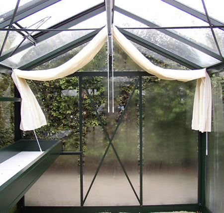 Royal Victorian Accessory Kit with narrow top shelf, seed-tray shelf, and full-length shade curtains inside green Victorian greenhouse