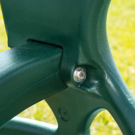 Close-up of green plastic swing frame joint with metal bolt and textured surface on dual glider swing accessory