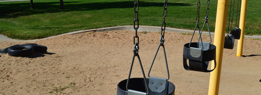 Park swing set with black toddler bucket swings