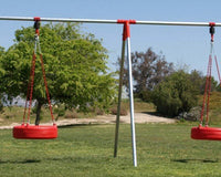 Two red tire swings hang from metal frame outdoors.