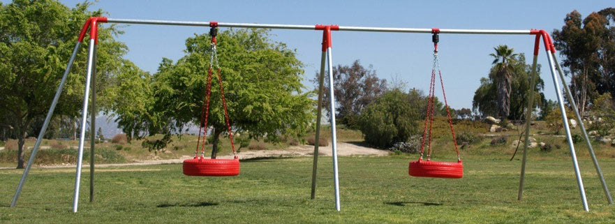 Two red tire swings hang from metal frame outdoors.