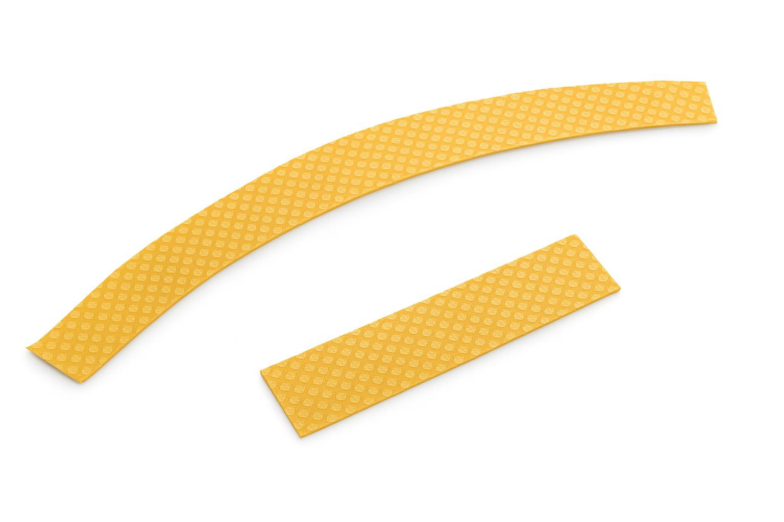 Two yellow textured tricycle path stripe pieces with diamond pattern, one curved and one straight, from Trike Paths striping kit