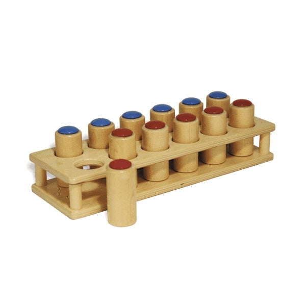 Sound Cylinders wooden tray with twelve red and blue-topped cylinders for auditory discrimination and sequencing exercises