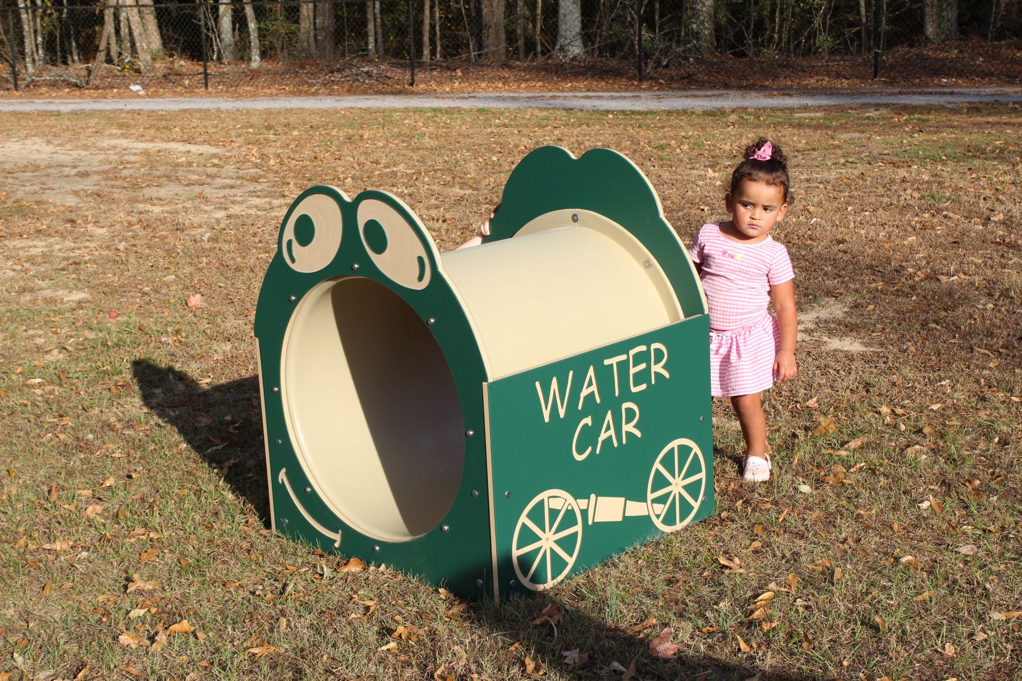 Water Car Single Tunnel climbing playset with frog face design and child standing on grass