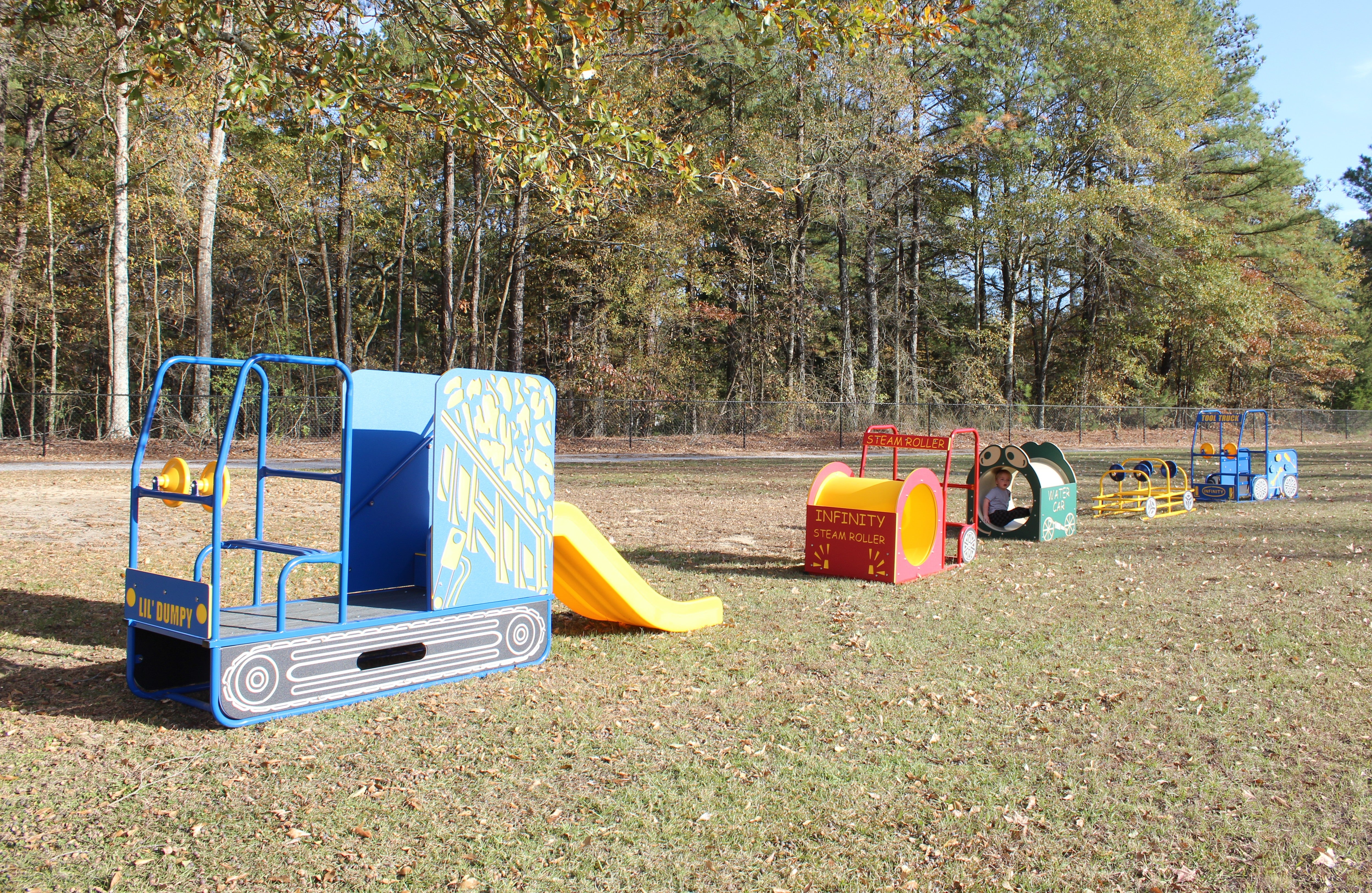 Road Crew Set with colorful construction-themed play structures including slide, steam roller, and tool truck on grass