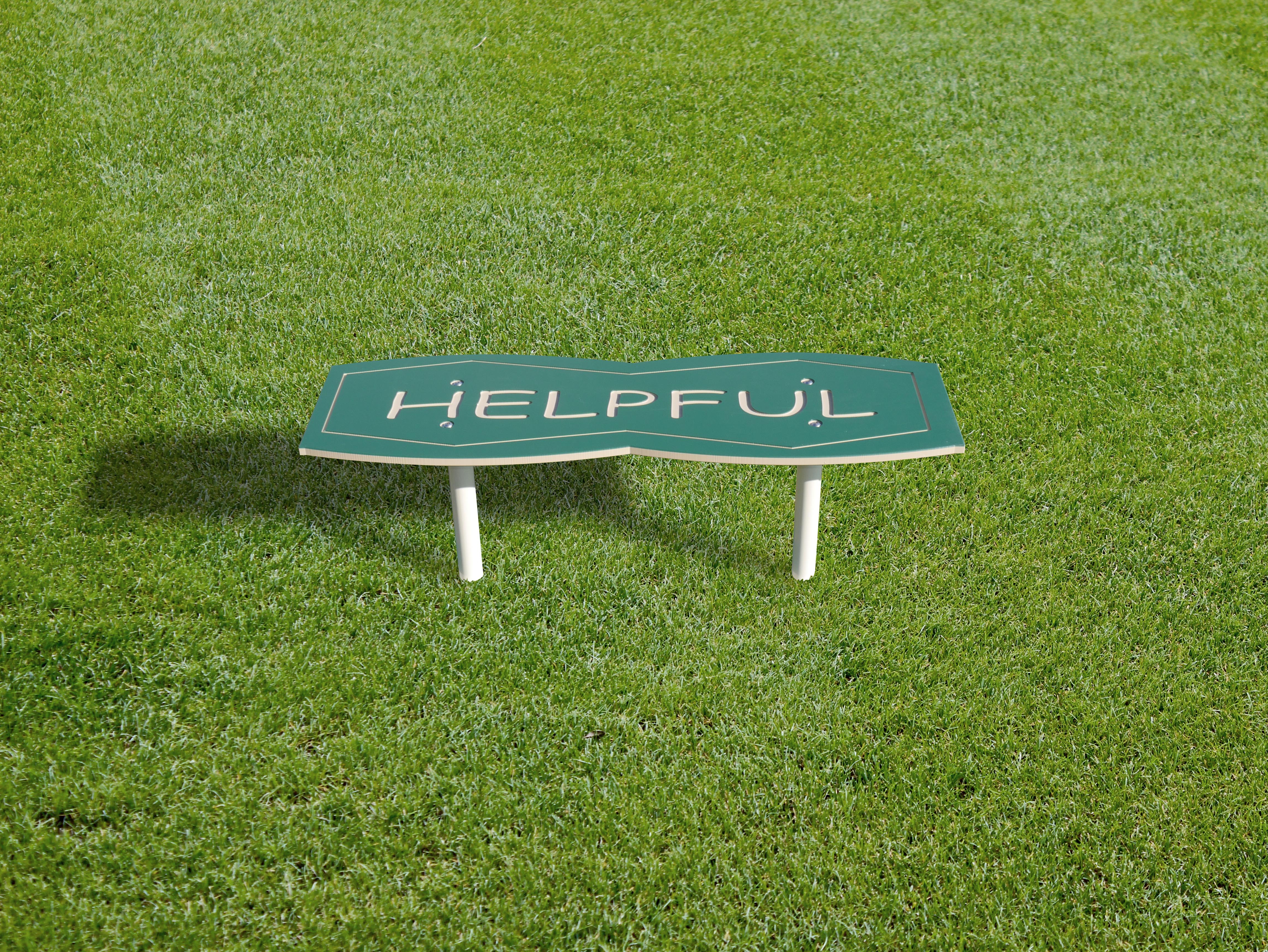 Green outdoor bench with "HELPFUL" text, durable weather-resistant material, kid-friendly design for parks and playgrounds