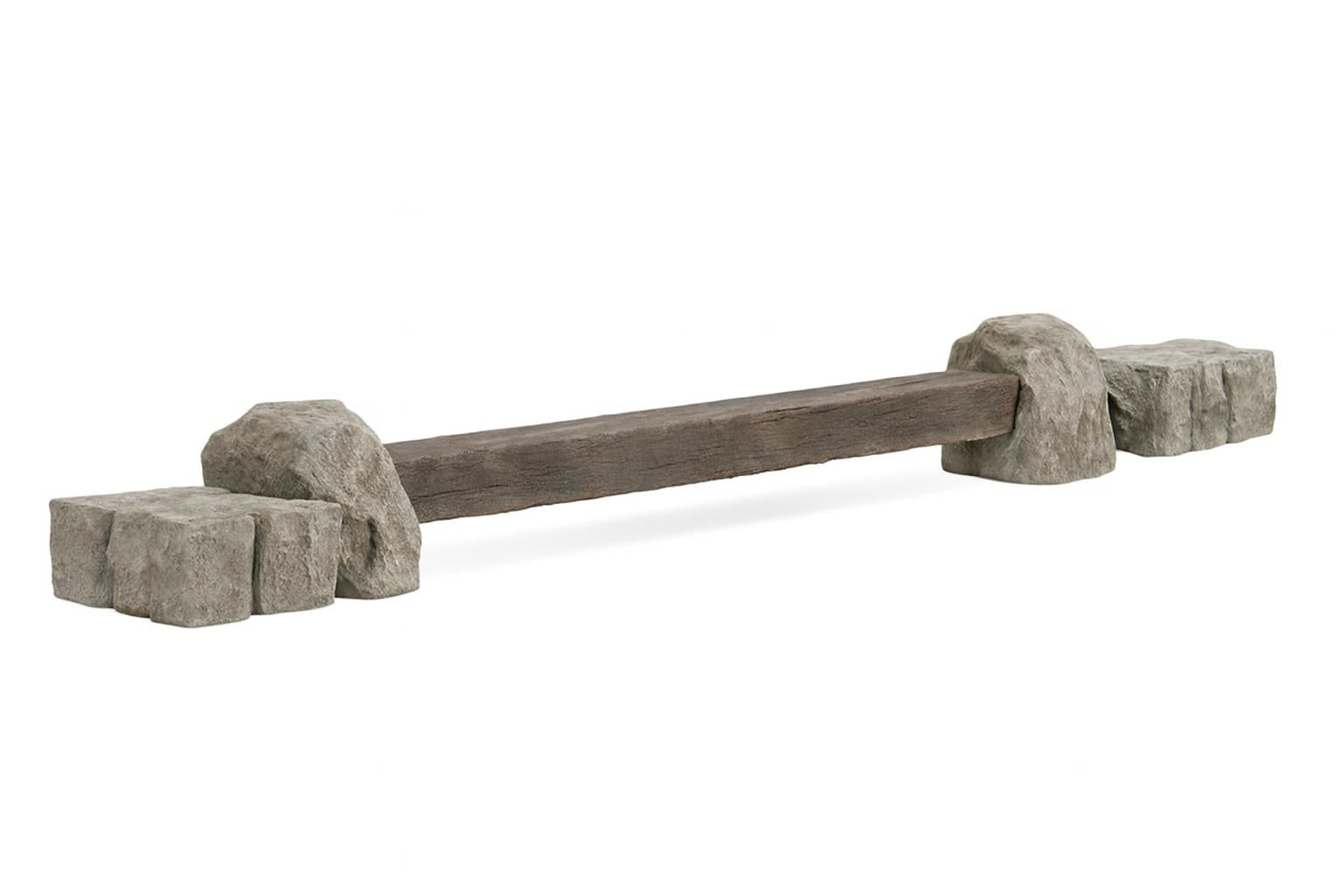 Rock Balance Beam with nature-inspired rock ends and textured composite railroad tie on outdoor mulch near stone pillars