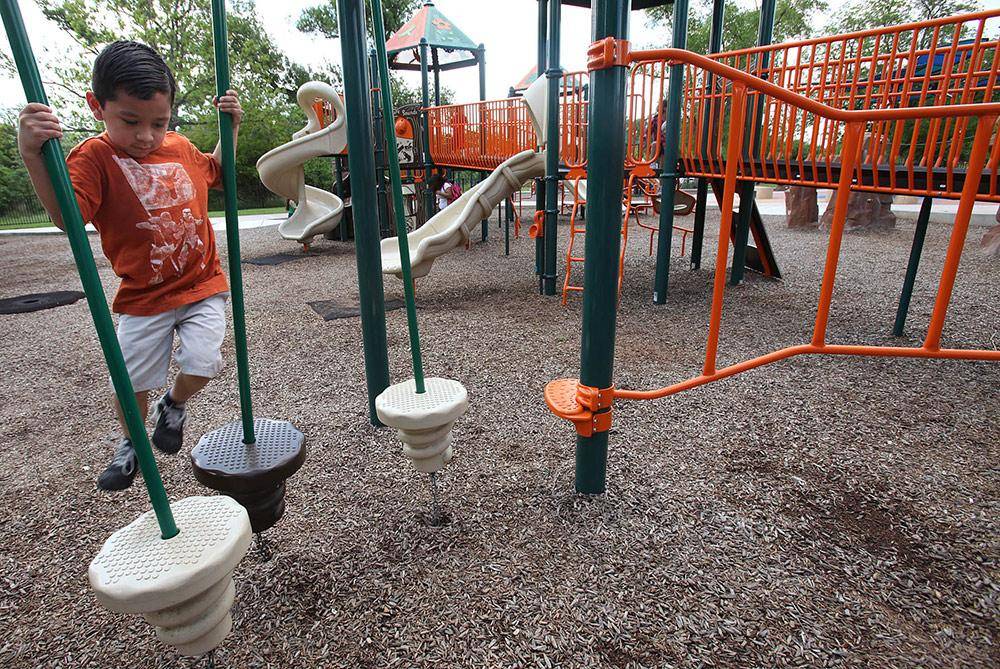 Kids Playing on Park Playground Equipment